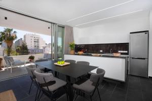 a kitchen and dining room with a table and chairs at Bridge House 201 - 3BR Penthouse in Limassol