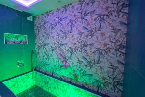 a bathroom with a painting on the wall at Luxury Royal House in Palermo