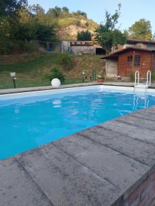 a swimming pool with a ball in the water at B&B di Paola e Luca in Borgo Tossignano +4 photos