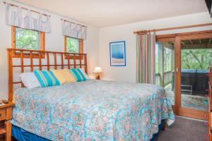 a bedroom with a bed and a large window at Dunewood in Corolla