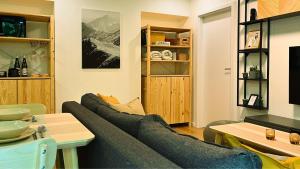 a living room with a couch and a table at Adventourist - Apartmán Terchová in Terchová