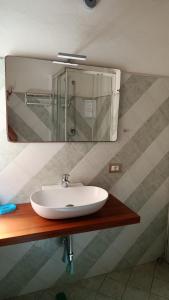 a bathroom with a sink and a mirror at Domus Case Vacanze civico del mare in Castellammare del Golfo +89 photos