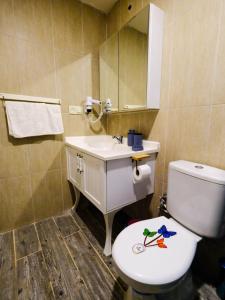 a bathroom with a toilet and a sink at KUPALA BEACH HOTEL in Büyükkeçeli +24 photos