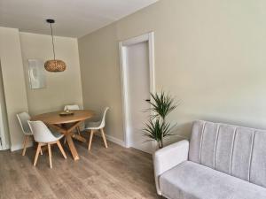 a living room with a table and a couch at Apartamento Villa Amparo in Laxe