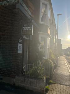 a building with a sign on the side of it at Kelston Guest House in Weymouth