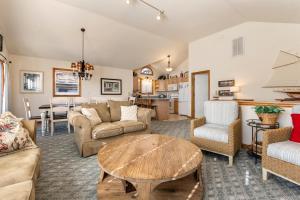 a living room with a couch and a table at Good Sun-Sations in Corolla