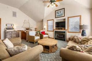 a living room filled with furniture and a fireplace at Good Sun-Sations in Corolla