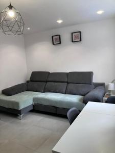 a living room with a couch and a table at Alojamientos centro in Yecla