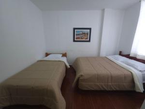 Giường trong phòng chung tại Hospedaje Grau