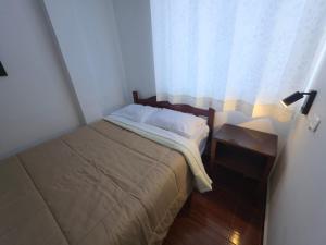 Giường trong phòng chung tại Hospedaje Grau