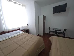 Giường trong phòng chung tại Hospedaje Grau +15 ảnh