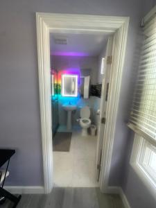 a bathroom with a toilet and a purple ceiling at Awesome deal! Room with private bathroom close to Kia Forum, Sofi Stadium and LAX airport in Inglewood +2 photos