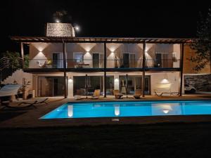 a villa with a swimming pool at night at Torre Menerva Viterbo piscina & SPA privata in Bullicame