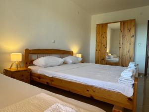 a bedroom with a large bed and a mirror at Apartments Bernarda 2 in Nin