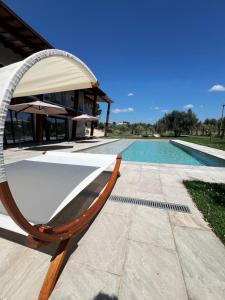 a swimming pool with a lounge chair next to a swimming pool at Torre Menerva Viterbo piscina & SPA privata in Bullicame