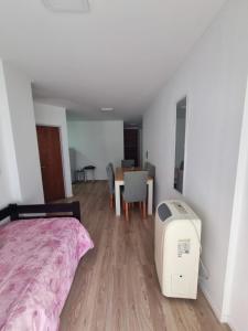 a bedroom with a bed and a table with chairs at Temporariorosario10 in Rosario