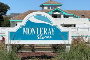a sign for a morley store in front of a building at Its All Good In Corolla in Corolla