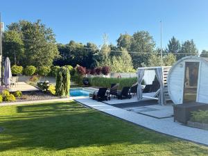 a garden with a gazebo and a pool at Sieburczynianka in Wizna