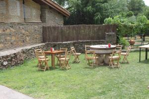 una mesa y sillas en un patio con una valla en Casa Rural La Flor del Naranjo, en Cadalso