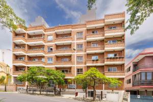 an apartment building with trees in front of it at Living Sol - Centric Urban Room in Santa Cruz de Tenerife