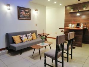 a living room with a couch and a table and chairs at Departamento Glasé 1 in Tarija