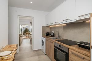 a kitchen with a sink and a dishwasher at Ammos seafront house in Adamantas