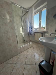 a bathroom with a shower and a sink at Willa Anna in Mielno