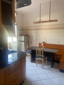 a kitchen with a table and two chairs in it at ALMIA casa vacanze in Fiumicino