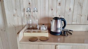 a counter with a coffee maker and two glass bottles at Sunyog Homestay in Pedong