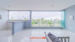 a room with a large window with a view of the ocean at Apartamento em Bertioga com vista para o mar in Bertioga +16 photos
