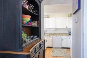 a kitchen with white cabinets and a black cabinet at Lauren Lee in Nags Head
