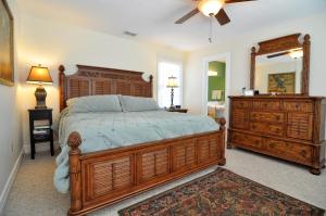 a bedroom with a large wooden bed and a dresser at Lauren Lee in Nags Head