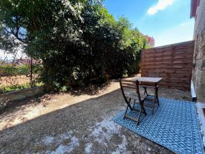 a bench sitting on a blue rug next to a table at Studio Avignon MONTFAVET in Avignon