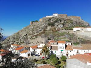 a town with a castle on top of a hill at Casa Rural Canchalejo in Montánchez +18 photos