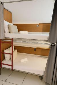 a room with two bunk beds and a curtain at Hospedaria Colonial - Pousada e Hostel in São Luís +15 photos