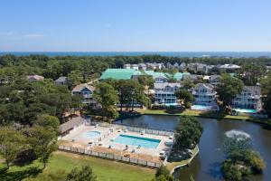 an aerial view of a home with a swimming pool and a river at Let Me Count The Waves in Corolla
