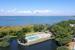 an aerial view of a house with a pool in the water at Let Me Count The Waves in Corolla