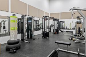 a gym with rows of treadmills and machines at Let Me Count The Waves in Corolla +35 photos