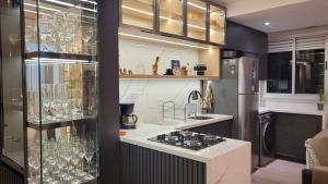 a kitchen with a stove and a counter top at Lindo apartamento centro de Floripa in Florianópolis +37 photos