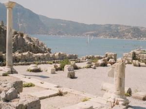 a group of ruins on a beach next to the water at Antonis Hotel in Kefalos