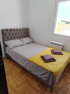 a bed with two towels on it in a bedroom at EXPO Prime New Belgrade Ledine in Ledine