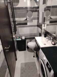 a small bathroom with a toilet and a sink at EXPO Prime New Belgrade Ledine in Ledine +6 photos