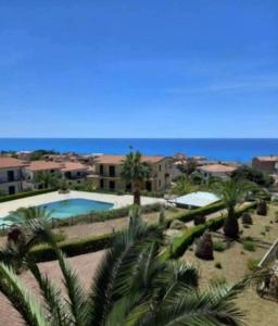 a view of a resort with a pool and palm trees at Parco Meridiana 25H in Scalea
