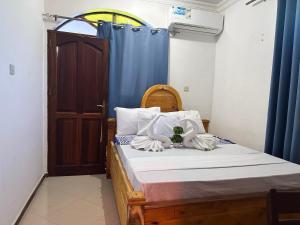 Postel nebo postele na pokoji v ubytování Hello Rafiki GuestHouse - Mkunazini + 12 fotografií