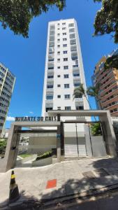 a tall white building with a sign in front of it at Lindo apartamento centro de Floripa in Florianópolis