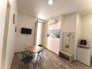 a small apartment with a table and chairs in a room at Cabot Cove in Gaeta