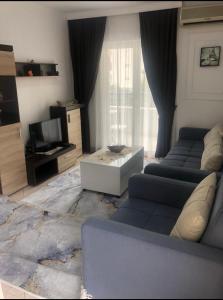 a living room with two couches and a television at Apartment Una in Becici