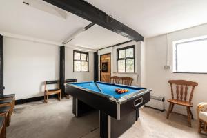 a room with a pool table in it at Cae Madog Barn in Llanbrynmair