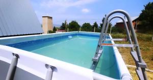 a swimming pool with a water slide in it at Cottage In Forest in Mtskheta