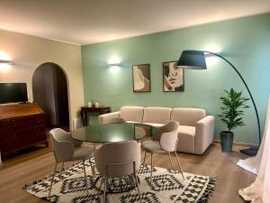 a living room with a couch and a table and chairs at Casa Mina in Taormina